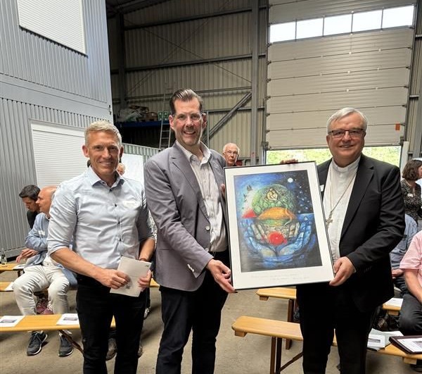 Bischof Karl-Heinz Wiesemann (rechts) überreicht ZAK-Vorstand Jan Deubig eine Schöpfungs-Darstellung des Priesters und Künstlers Sieger Köder